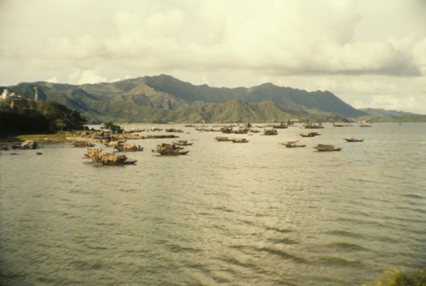 Fishing boats off Tai Po. Mountains form a backdrop to a fleet of Chinese sampans that bob up and