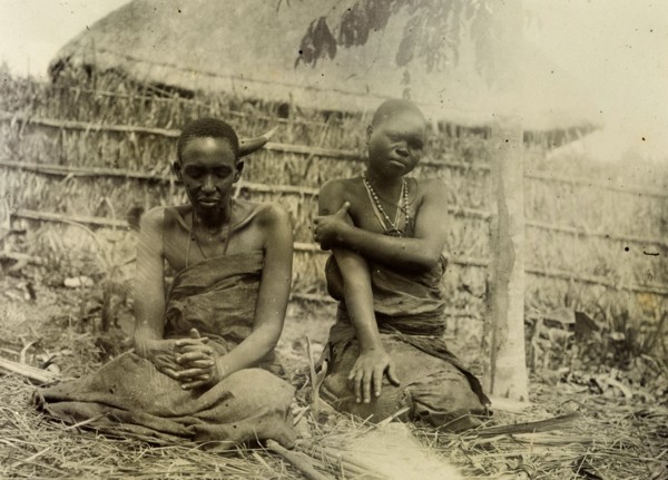 Sufferers from sleeping sickness, Uganda. A man and a woman dressed in bark cloth are seated