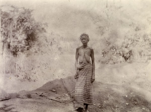 Woman rural labourer, Morocco. Outdoors portrait of a thin, elderly woman. She wears a long cloth