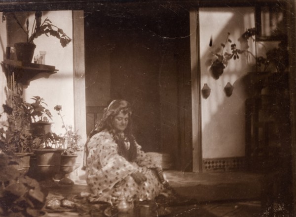Mrs Russi dressed as a 'moorish woman'. Mrs Russi, a European woman, sits in the doorway of a