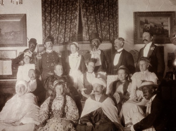 European fancy dress party, Morocco. Interior shot of European men and women dressed up in variety