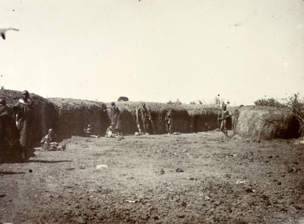 Outside a Maasai village. A group of Maasai are pictured outside the protective mud wall of their