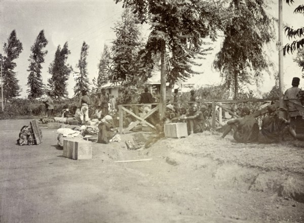 Frederick Stanbury's porters. Frederick Stanbury's safari porters wait by a roadside with numerous