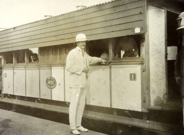 Colonel Will' at Kisumu. A European man identifed as 'Colonel Will' rests his hand on a bar running