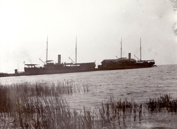 Lake steamers on Lake Victoria. The masts and funnels of two large lake steamers are silhouetted