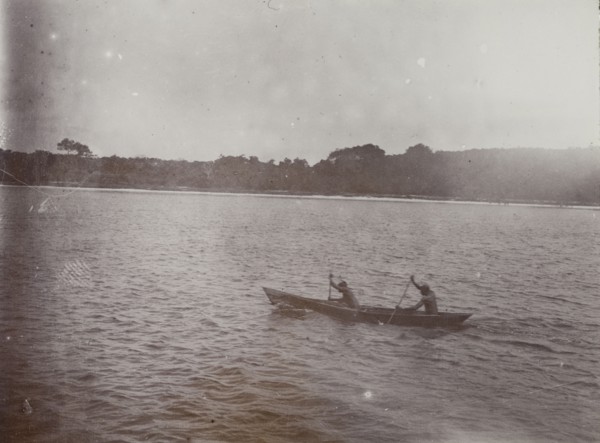 Canoe on Lake Victoria. Two men paddle a small wooden canoe on Lake Victoria. Lake Victoria,
