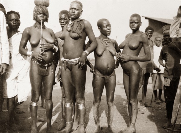 Luo women at Kisumu. Portrait of four nearly naked Luo women at a local market. Kisumu, British