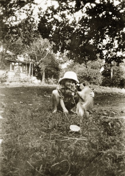 When you were about 5 1/2. A young Charles Trotter squats down to play with his pet Vervet monkey