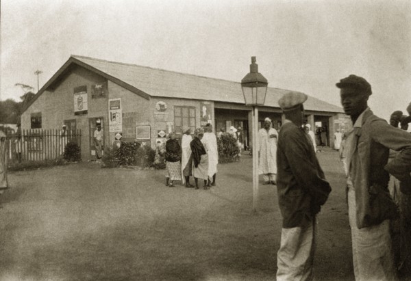 Jos railway station. African men and women mill around on the street outside Jos railway station.