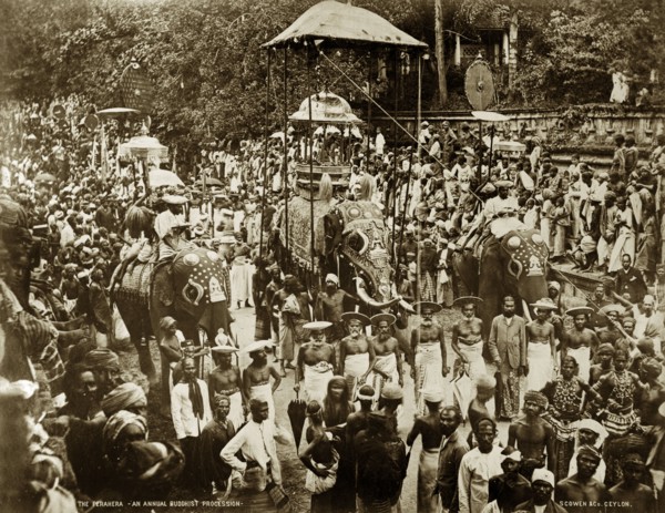 Buddist perahera in Ceylon. Crowds of people pack the streets at an annual Buddhist perahera