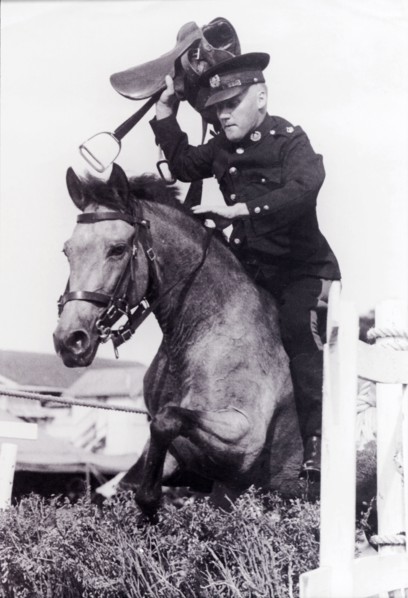 Leslie Slater holds his breath. Uniformed British police officer, Leslie Slater, holds his breath