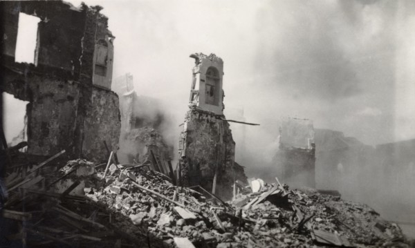 Aftermath of Arab riots in Aden, 1947. The smoking ruins of a building reduced to rubble in the