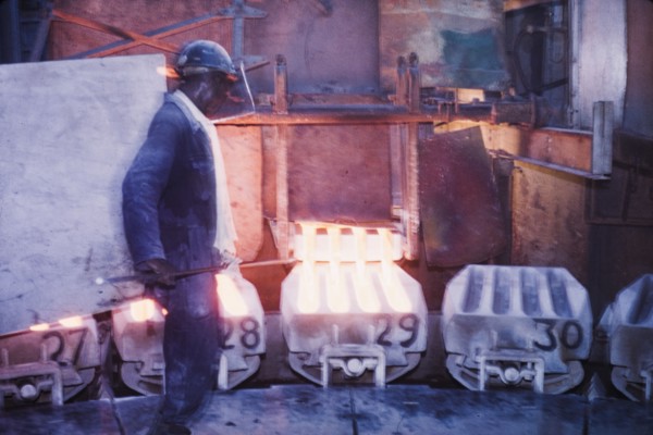 Moulding copper, Nkana-Kitwe. A smith oversees the pouring of refined copper from a furnace into