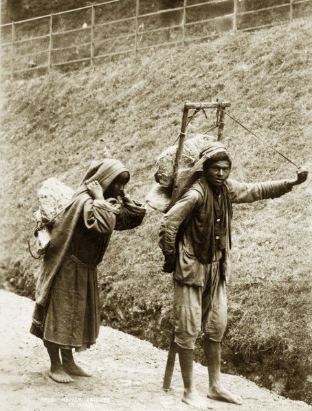 Nepalese labourers. A barefoot Nepalese couple, labelled in an original caption as 'coolies',