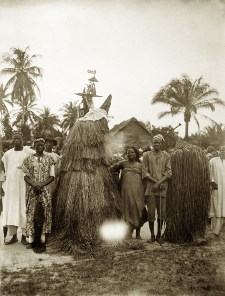 Tassled juju costumes. Two juju practioners dressed in tassled costumes designed to cover their