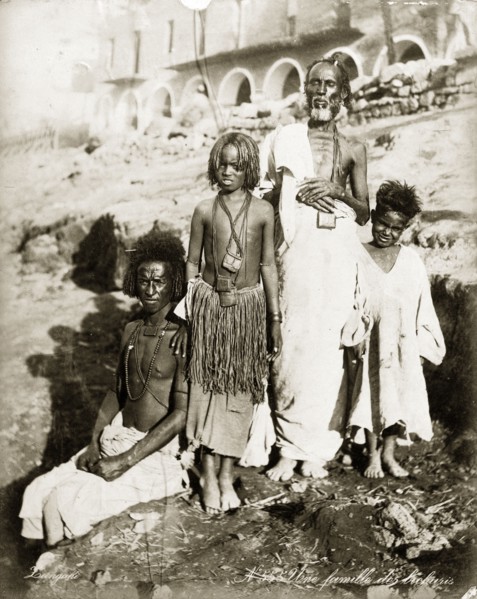 Portrait of a Bischarin family. Group portrait of two adult men and two children, possibly boys.