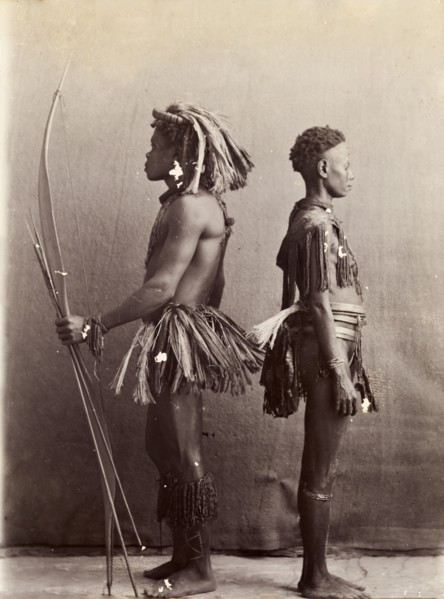Andaman Islanders. A man and a woman from the Andaman Islands stand, back to back in profile,
