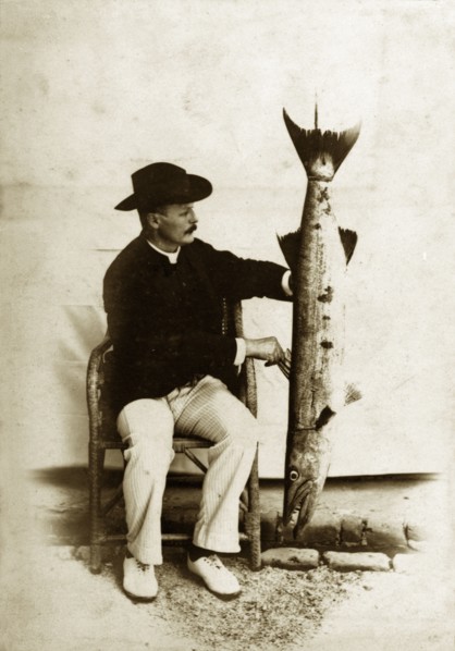 Prize fish, Andaman Islands. A European man poses proudly for the camera, displaying a large,