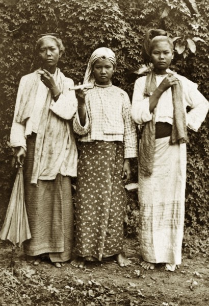 Three Burmese women. Outdoors portrait of three young Burmese women wearing traditional dress.