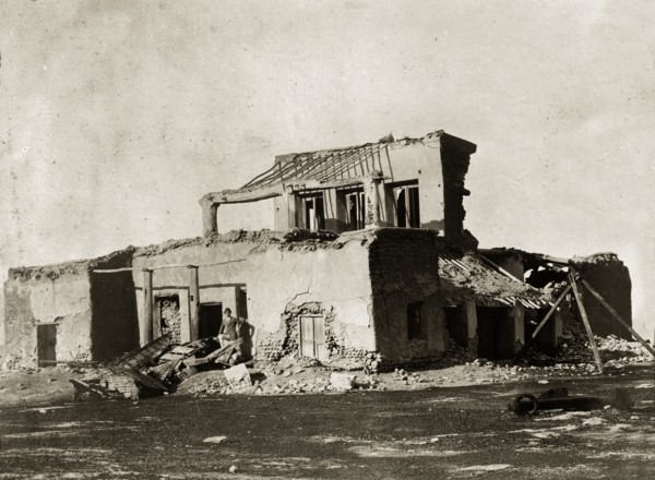 Remains of the hospital at Basidu. A European man identified as 'Lieutenant Poyntz' poses amidst