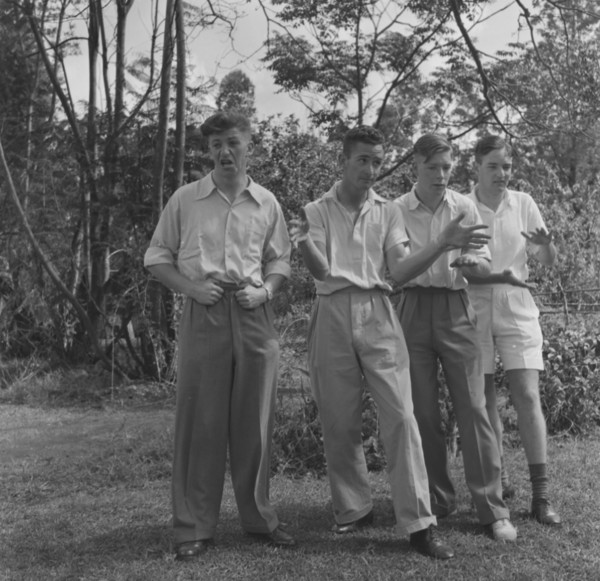 Cabaret practice. Four young men strike a pose as they practice their cabaret routine for a square