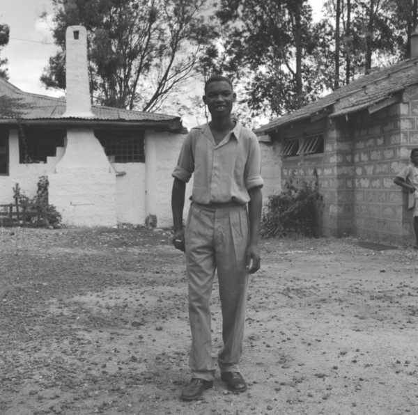 Off-duty Kenyan bartender. An off-duty Kenyan bartender relaxes with a cigarette, dressed in casual