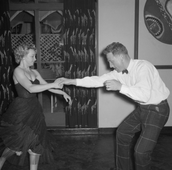 Dancing at the Equator Club. A couple dance energetically at the Equator Club. The woman, identifed