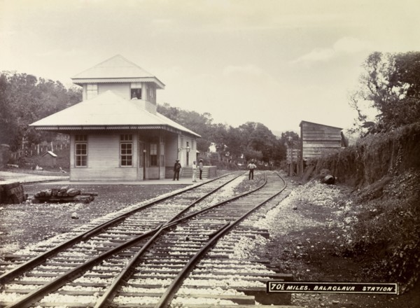 Balaclava railway station. A group of men loiter on the platform and track outside Balaclava