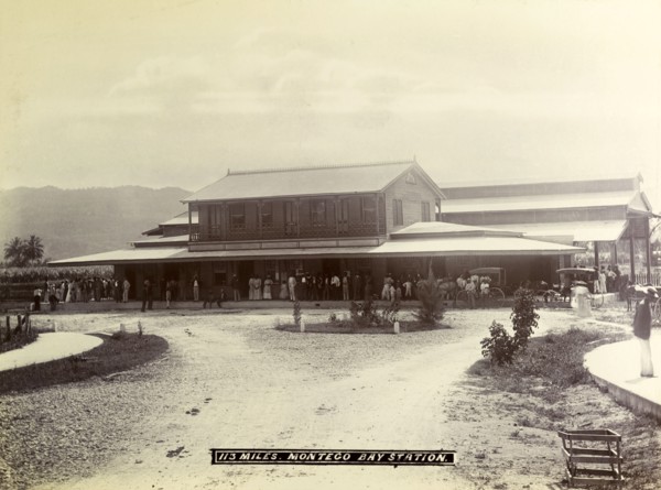 Montego Bay railway station. A crowd of passengers waits on the veranda outside Montego Bay station
