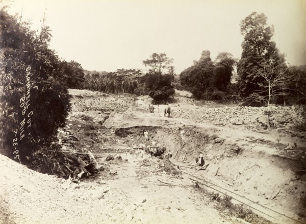 Railway construction site. Labourers at work on a construction site, landscaping a bank of earth to