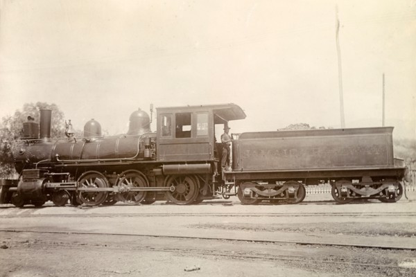 American steam locomotive, Jamaica. An American-manufactured steam locomotive sits on rails at a