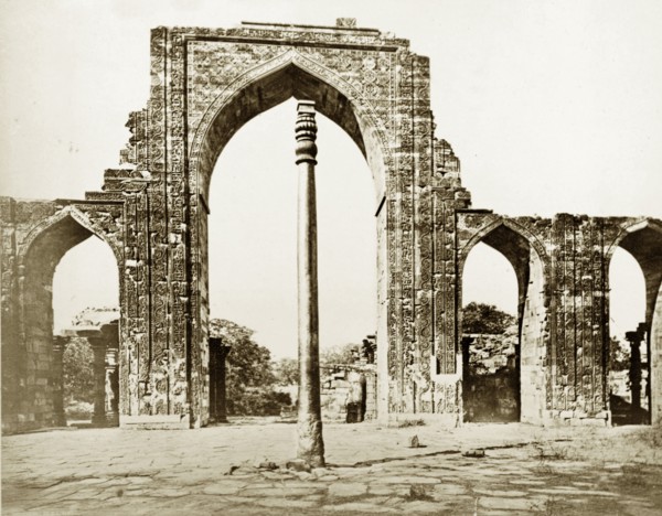 The Iron Pillar at Qutb, circa 1865. The Iron Pillar stands before the ruins of Quwwat-ul-Islam