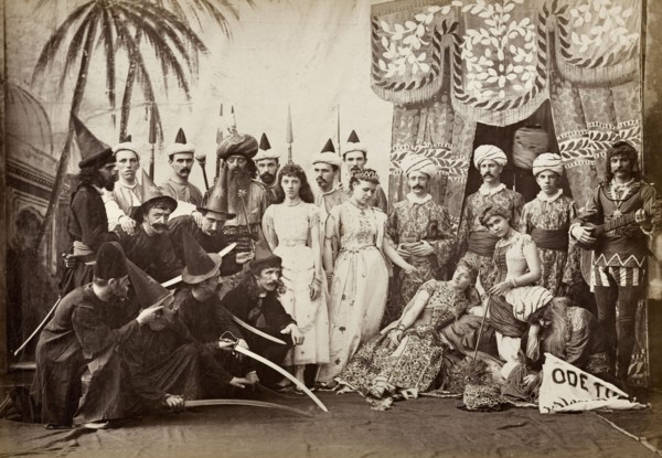 Cast of Lalla Rookh. The European cast in a pantomime of Lalla Rookh. The group stand on stage in