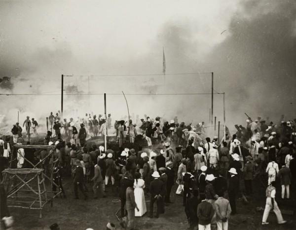 Fire at the Coronation Durbar. Onlookers face a cloud of smoke emitting from a fire at the