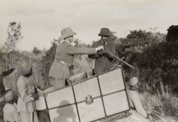 Assisting King George V. A royal aide assists King George V (r.1910-36) to load his rifle during a