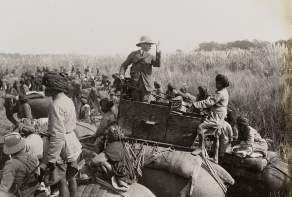 The Duke of Teck gesticulates. The Duke of Teck (1868-1927) stands up in his elephant's howdah,