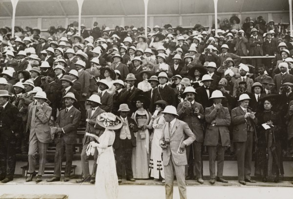 Spectators at a steeplechase. European, Indian and Eurasian spectators watch a steeplechase from