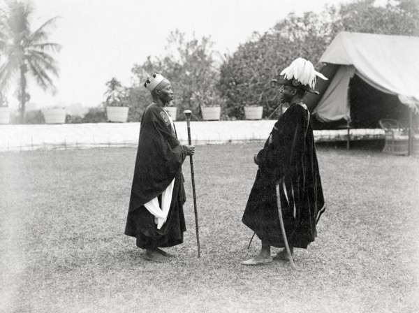 Two Bechuanaland chiefs. Two finely dressed Bechuanaland chiefs stand facing each other at an