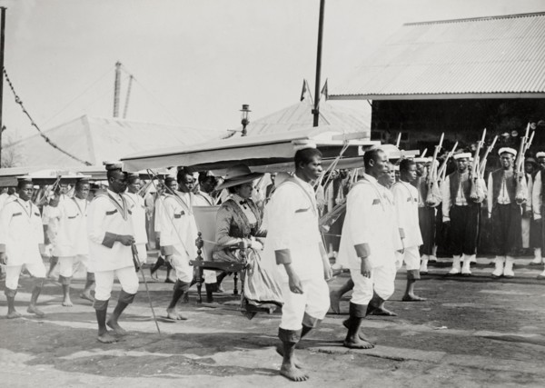 Duchess of Connaught in a portable chair. The Duchess of Connaught is carried along in a portable