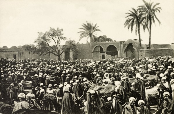 Market at Giza. A throng of people crowd an open air market at Giza. Giza, Egypt, circa 1900. Giza,