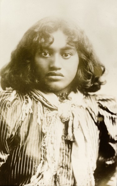 Young Maori woman. Studio portrait of a young Maori woman wearing typically Western dress including