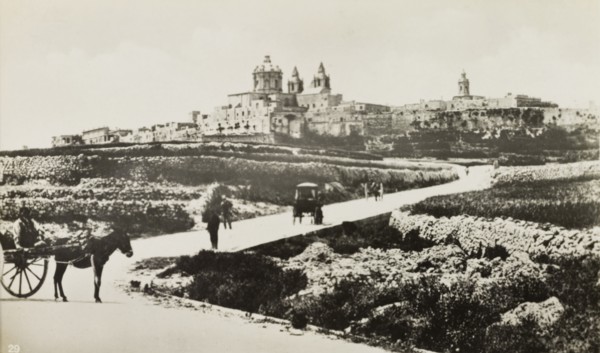 Outskirts of Mdina. People travel along a road on the outskirts of Mdina, the 'citta vechia' or old