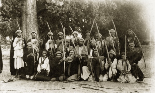 Kafir archers, Pakistan. A group of Kafir archers pose for the camera, their arrows pulled back as