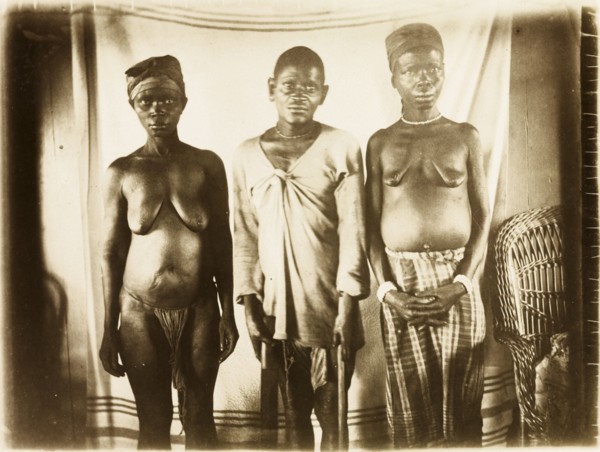 Inhabitants of Bioko. Portrait of a two women and a man from Bioko, posed standing against a