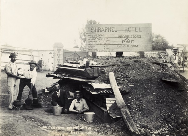 Making tea at the 'Shrapnel Hotel'. British men make tea outside a makeshift bomb shelter, jokingly