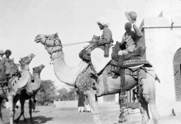 A hunting trip by camel. Sir Henry Staveley Lawrence, Collector of Karachi, raises his solatopi hat