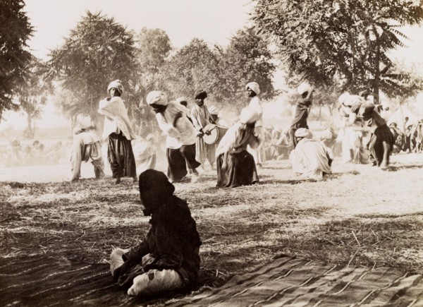 Indian drummers. A drummer is encircled by male dancers in traditional Indian dress during an