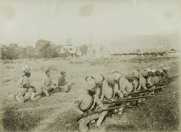 Practising a shooting stance. Turbaned Indian Military and Civil Police officers practice their