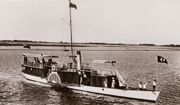Paddle steamer on the River Nile. A paddle steamer named 'The Elfin' travels along the River Nile,