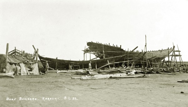 Boat builder's yard in Karachi. Two boats encased in scaffolding undergo construction at a boat
